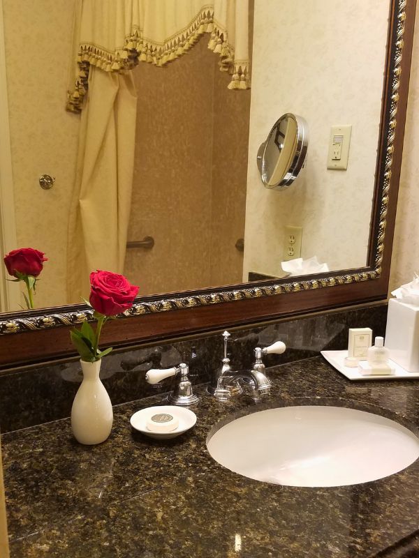 A single red rose on the bathroom vanity at The Inn at Biltmore